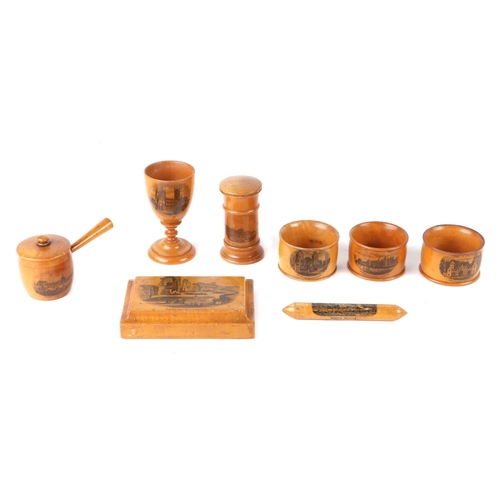 384 - A group of Victorian Mauchlinware to include an egg cup, needle case and desk weight (8).