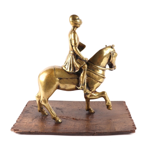 389 - A brass / polished bronze of a medieval knight on horseback, 32cms high.