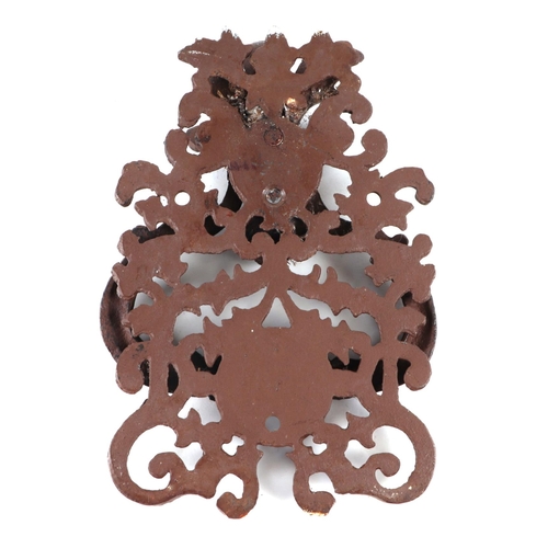 394 - A large steel door knocker with pierced scroll decoration, 13cms wide.