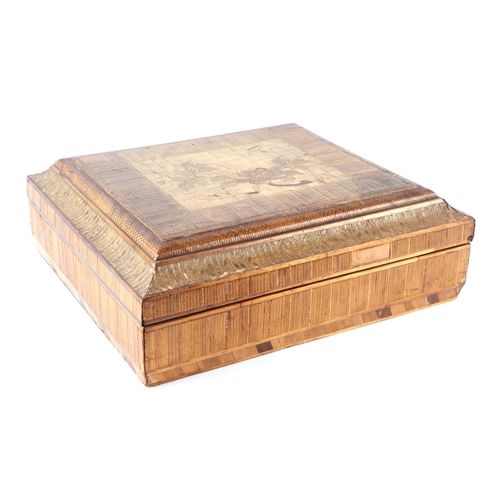 402 - A Japanese straw work rectangular box, the lid decorated with a spray of flowers, 33cms wide.