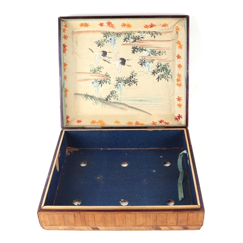 402 - A Japanese straw work rectangular box, the lid decorated with a spray of flowers, 33cms wide.