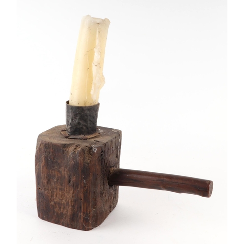 405 - A primitive oak block candlestick, 13cms wide.