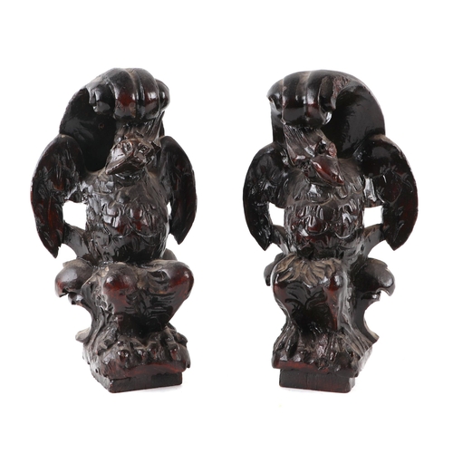 411 - A pair of 17th century style (probably 19th century) carved oak griffins, approx 24cms high (2).