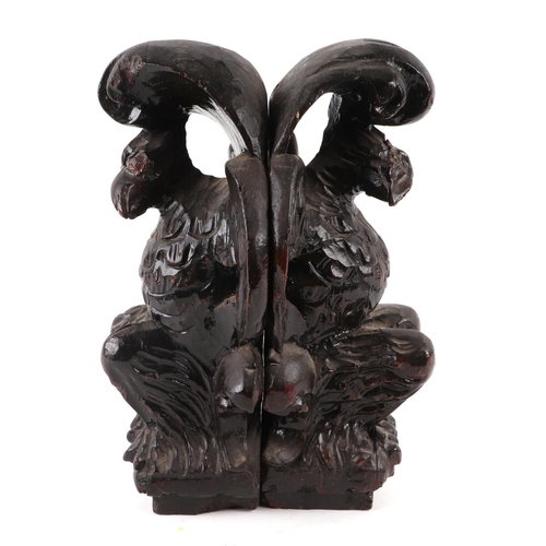 411 - A pair of 17th century style (probably 19th century) carved oak griffins, approx 24cms high (2).