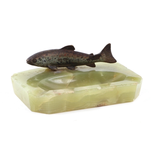 419 - An early 20th century green onyx ashtray surmounted with a cold painted bronze trout, 13cms wide.