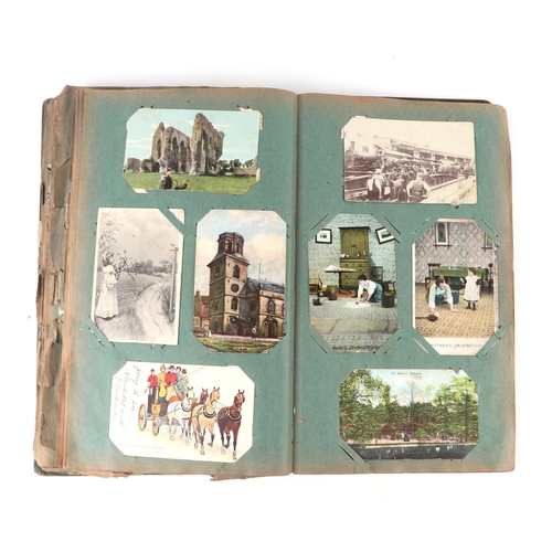 42 - An early 20th century postcard album to include Christmas, comical and topographical examples.