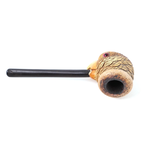 420 - A corn cob pipe, the bowl carved in the form of a parrot with glass eyes, 15cms long.