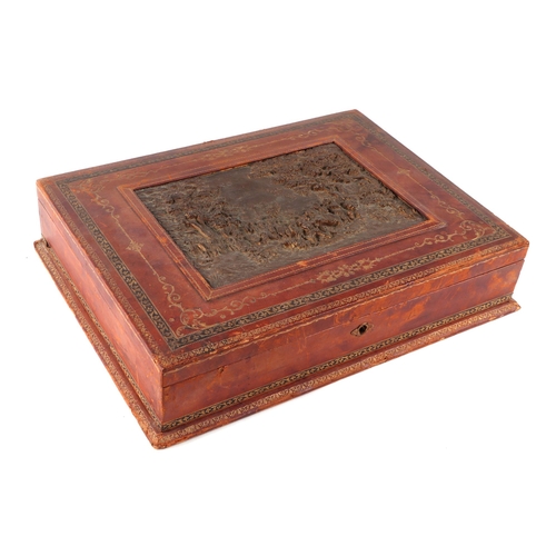 427 - A tooled leather table top box, the lid inset with a hunting scene, with a fitted interior, 42cms wi... 