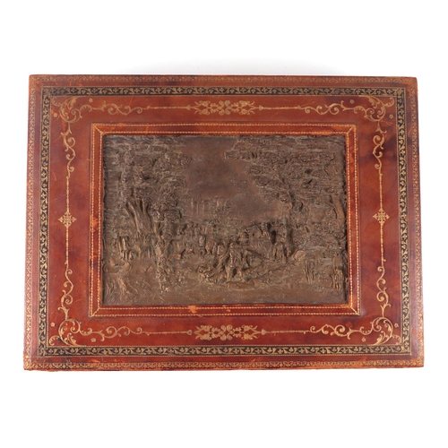 427 - A tooled leather table top box, the lid inset with a hunting scene, with a fitted interior, 42cms wi... 