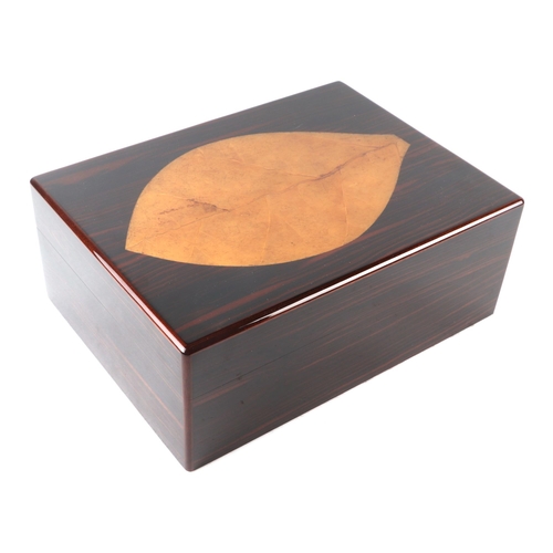 438 - A Davidoff Zino coromandel humidor, 31cms wide, with original instructions and silk lined box.