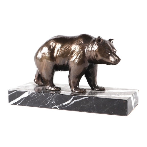 453 - A bronzed spelter figure of a grizzly bear on a figured marble plinth, 17cms wide.