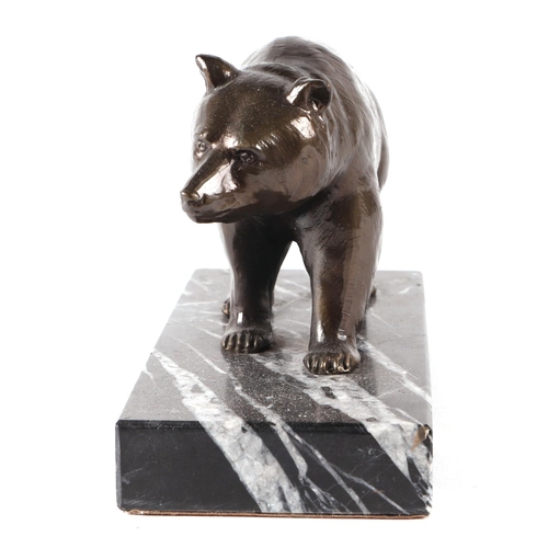 453 - A bronzed spelter figure of a grizzly bear on a figured marble plinth, 17cms wide.