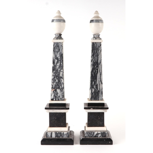 454 - A pair of black and grey figured marble obelisks, 45cms high (2).Condition ReportOne obelisk is deta... 