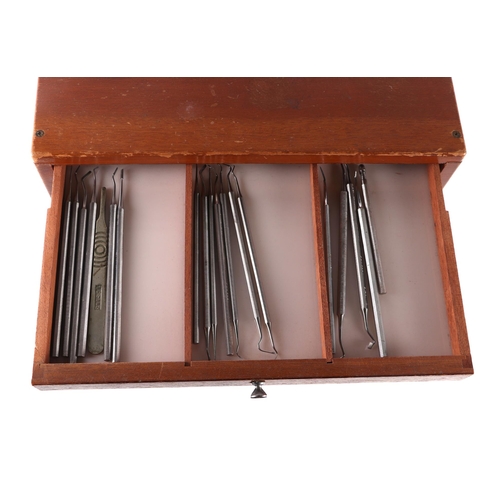 469 - A dentists table top seven-drawer graduated chest containing a selection of dental  instruments, 33c... 