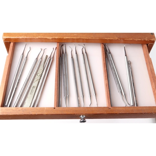 469 - A dentists table top seven-drawer graduated chest containing a selection of dental  instruments, 33c... 