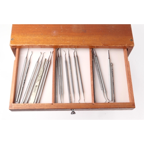 469 - A dentists table top seven-drawer graduated chest containing a selection of dental  instruments, 33c... 