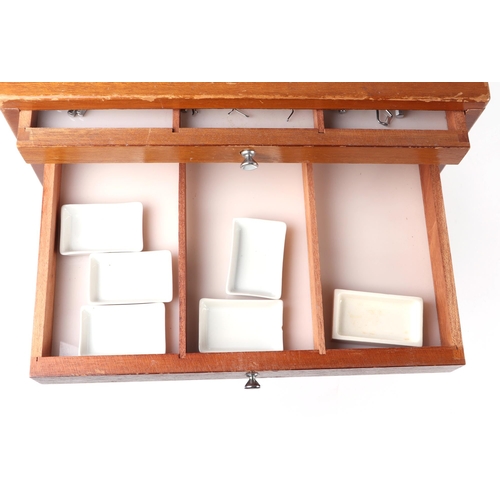 469 - A dentists table top seven-drawer graduated chest containing a selection of dental  instruments, 33c... 