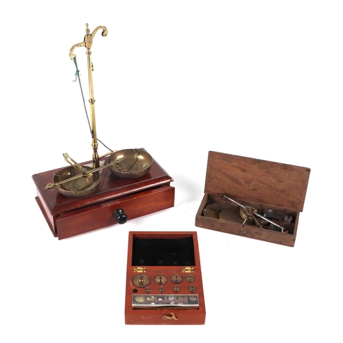 475 - A set of 19th century opium or chemist scales on a mahogany box base, 22cms wide; together with anot... 