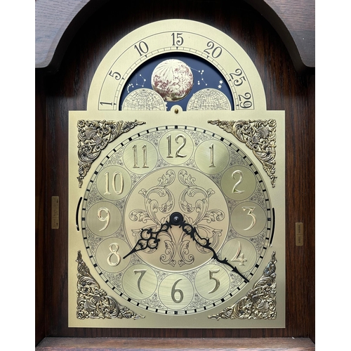 484 - An oak cased modern longcase clock, the brass moon phase dial with Arabic numerals and having a thre... 