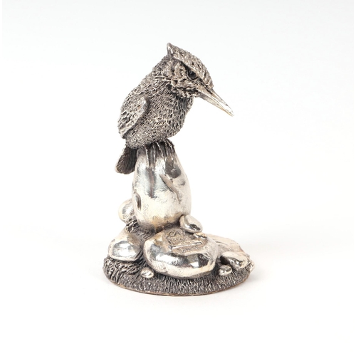 526 - A Country Artists silver model of a kingfisher perched on a stone, 7.5cms high.