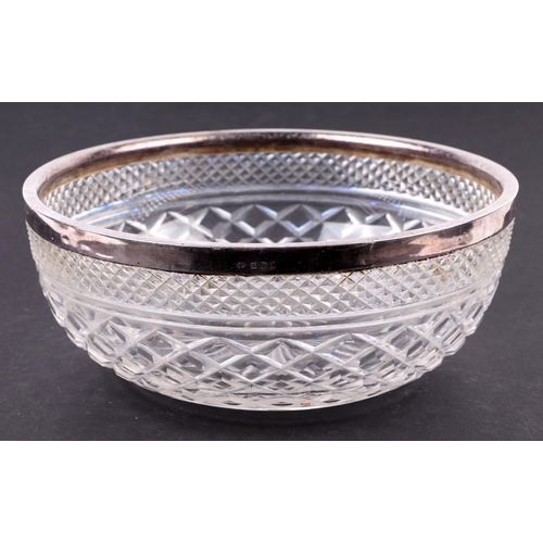 534 - A silver rimmed Mappin & Webb fruit bowl, various silver spoons and napkin rings, various dates and ... 