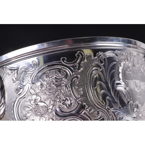 539 - A large heavy 18th century Irish silver twin-handled trophy cup with 'S' scroll handles, repousse fo... 