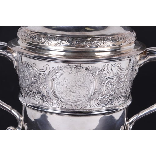 539 - A large heavy 18th century Irish silver twin-handled trophy cup with 'S' scroll handles, repousse fo... 