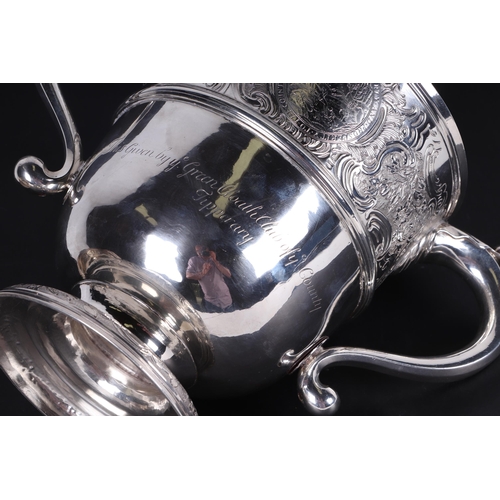 539 - A large heavy 18th century Irish silver twin-handled trophy cup with 'S' scroll handles, repousse fo... 