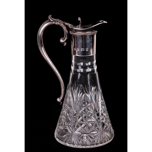 545 - A George III style claret jug with silver mounts, scroll thumbpiece and acanthus leaf capped scroll ... 