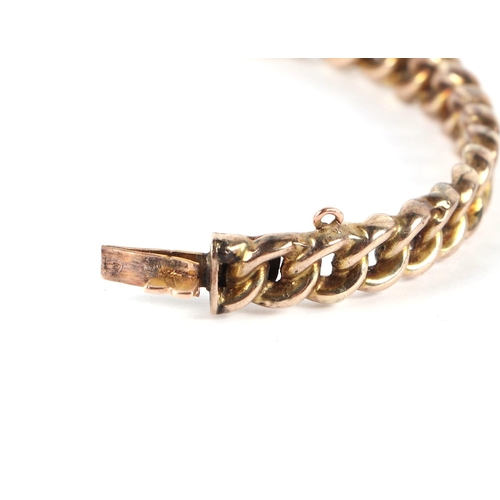 559 - A 9ct gold chain link hinged bangle, 12.3g.