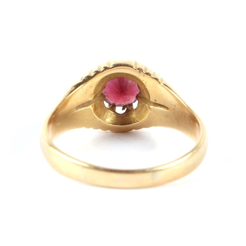 560 - An 18ct gold garnet set gentleman's ring, approx UK size W, 8.5g.