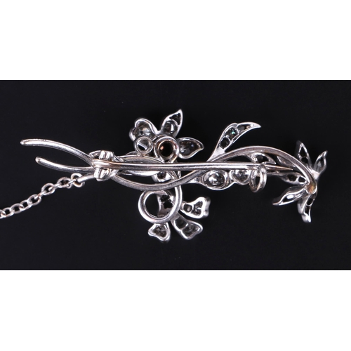 561 - A white metal diamond mounted floral spray and insect brooch, 5cms long, 8.1g.