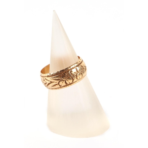 567 - An 18ct gold child's ring with engraved decoration, approx UK size H.