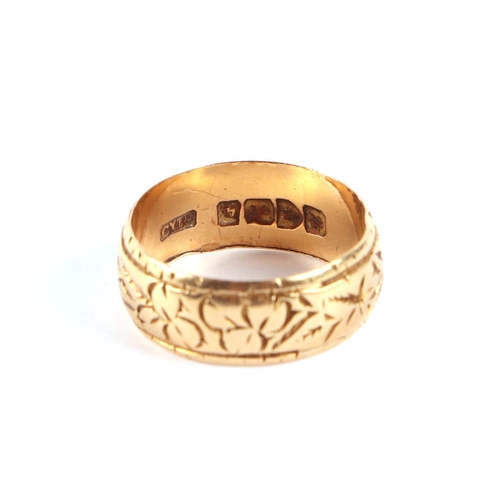 567 - An 18ct gold child's ring with engraved decoration, approx UK size H.