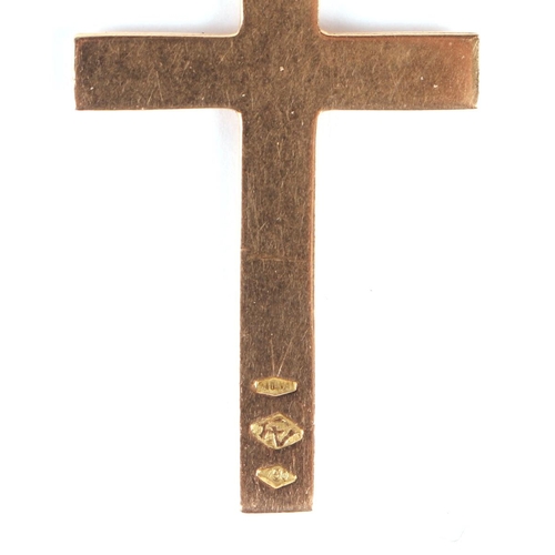 569 - An 18ct gold cross pendant; together with an 18ct gold charm in the form of a winged lion; and a yel... 