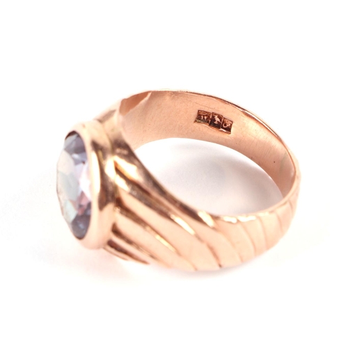 576 - An Egyptian gold ring (probably high carat) set with a large amethyst, approx UK size P, 7.8g.