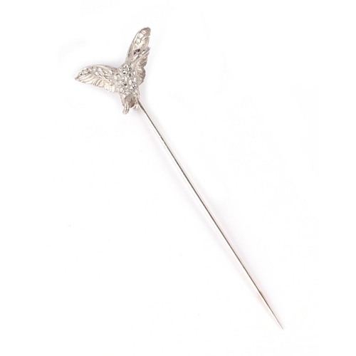 579 - A white metal diamond set stick pin modelled as a duck in flight, 5.1g.