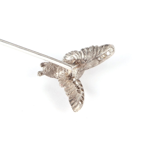 579 - A white metal diamond set stick pin modelled as a duck in flight, 5.1g.