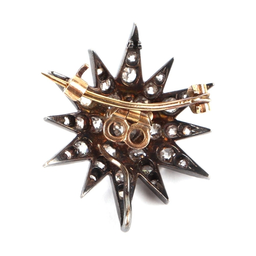 580 - A Victorian yellow and white metal mounted diamond set star brooch, 2.5cms diameter, the central dia... 