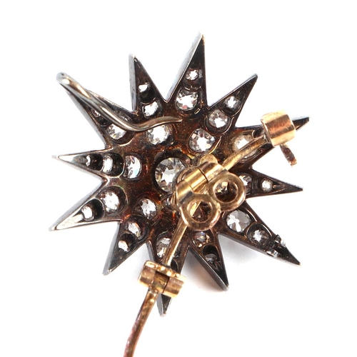 580 - A Victorian yellow and white metal mounted diamond set star brooch, 2.5cms diameter, the central dia... 