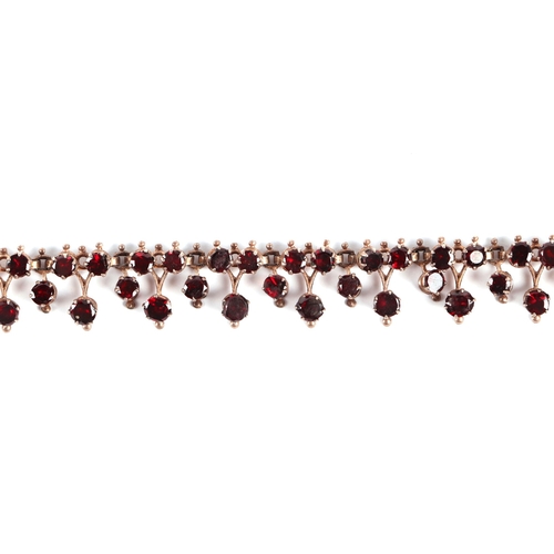 588 - A Victorian yellow metal mounted  garnet set necklace with 9ct gold clasp, 44cms long, 14.8g.