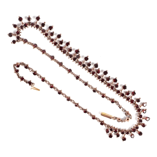 588 - A Victorian yellow metal mounted  garnet set necklace with 9ct gold clasp, 44cms long, 14.8g.