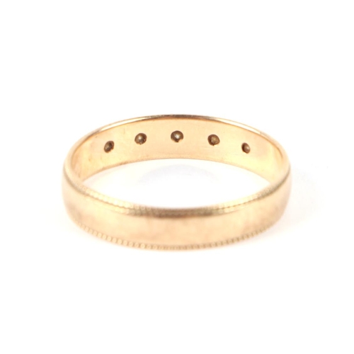 596 - A 9ct gold ring set with five small diamonds, approx UK size M, 1.9g.