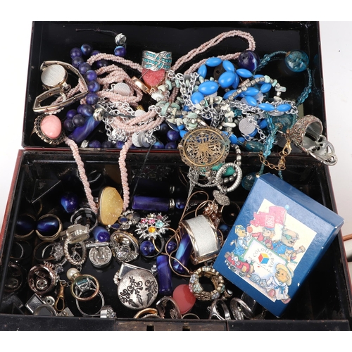 604 - A quantity of assorted costume jewellery to include necklaces and rings contained within a tin money... 