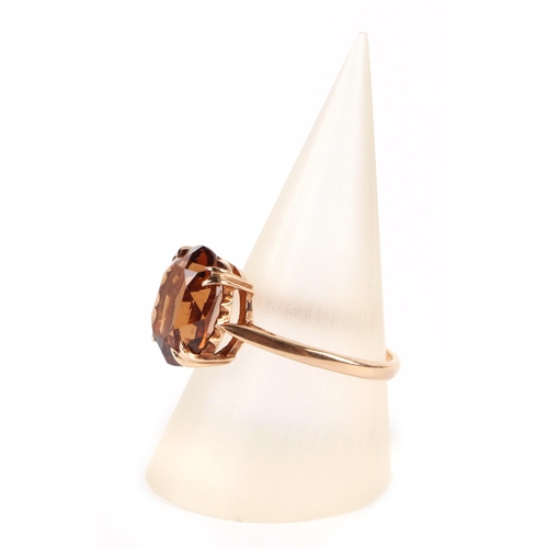 606 - A 9ct gold dress ring set with a large citrine, approx UK size O, 2.6g.