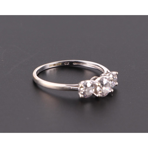 607 - A 9ct white gold ring set with three white stones, approx UK size N, 1.6g.