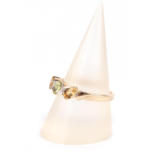 612 - A 9ct gold peridot, citrine and diamond ring, approx UK size N, 2.6g.