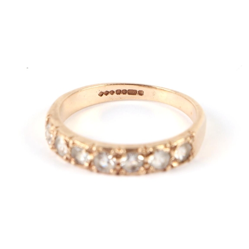 613 - A 9ct gold half eternity ring set with seven white stones, approx UK size K, 1.9g.