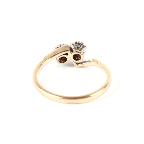 614 - A 9ct gold two-stone diamond crossover ring, approx UK size M, 1.8g.