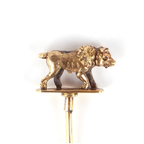 616 - A Victorian boxed yellow metal stick pin, the terminal in the form of a bull, 7cms high, 2.8g.